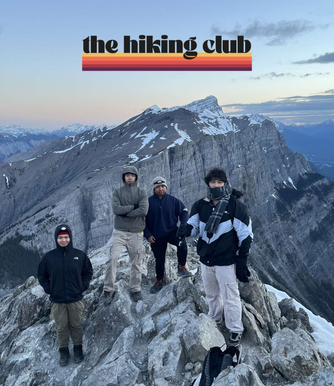 The Hiking Club Standing on a Mountain Peak in Banff Alberta